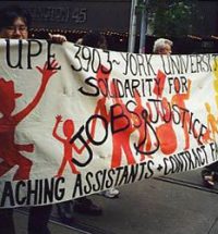 Union members holding a banner with red silhouettes of people. The banner text reads "CUPE 3903 ~ York University. Solidarity for Jobs & Justice. Teaching Assistants + Contract Faculty".